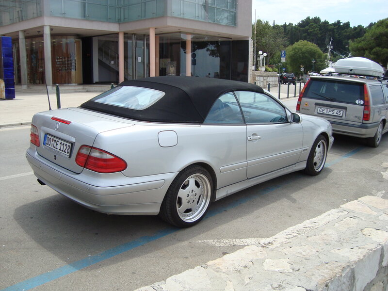 Silver convertible parked on street