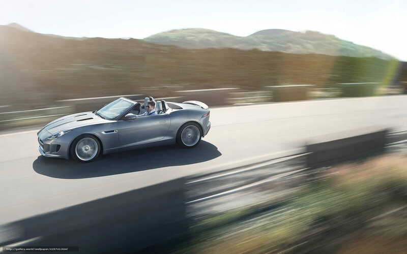 Silver convertible sports car in motion
