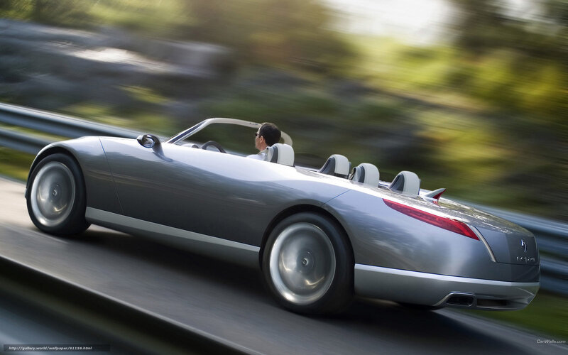 Silver convertible sports car in motion