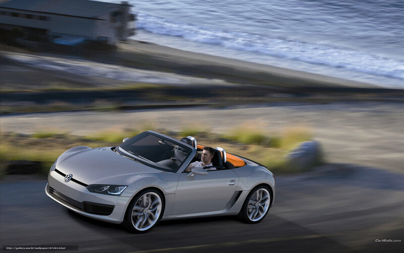 Silver convertible sports car on coastal road
