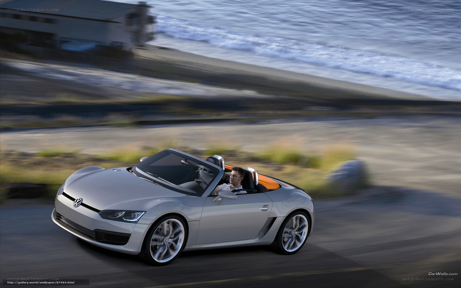 Silver convertible sports car on coastal road