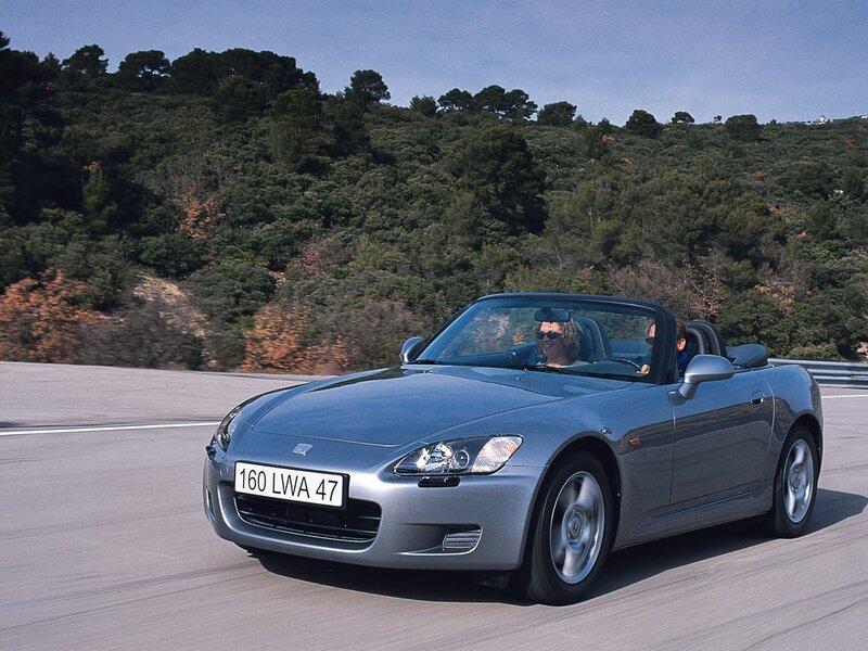 Silver convertible sports car on road