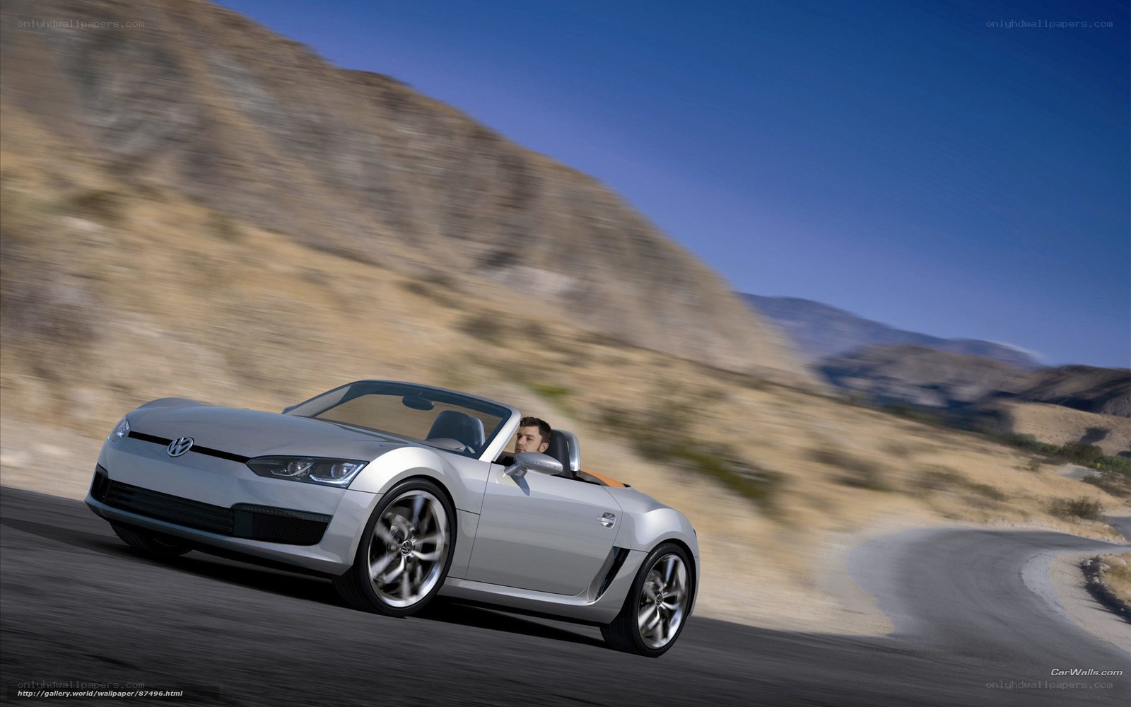 Silver convertible sports car on road