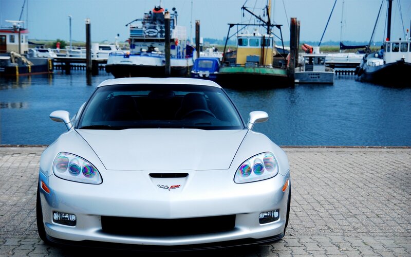 Silver Corvette at a marina