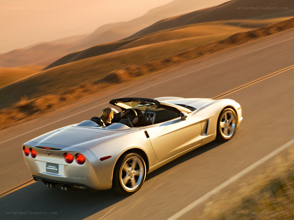 Silver Corvette convertible on road