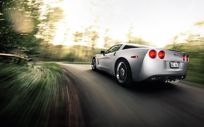 silver corvette driving on road