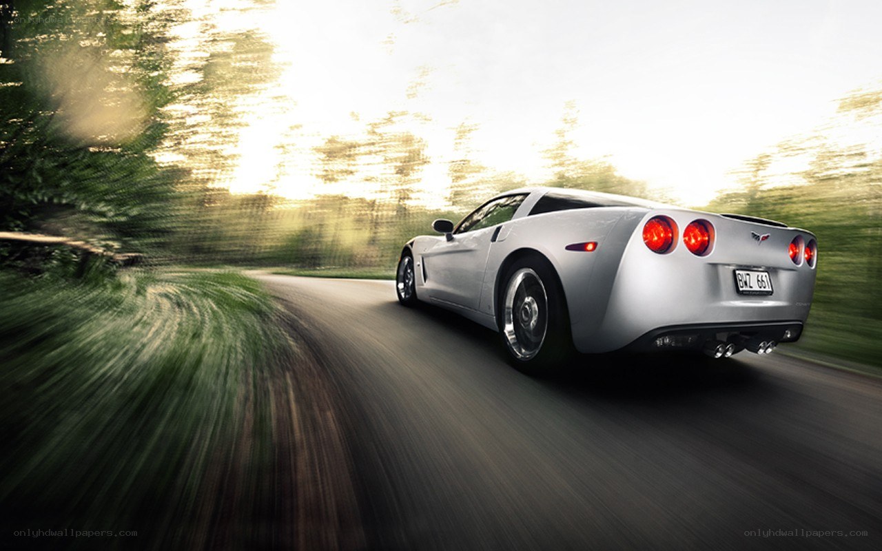 silver corvette driving on road