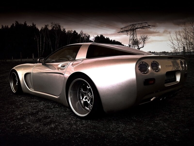 Silver Corvette in a dark field