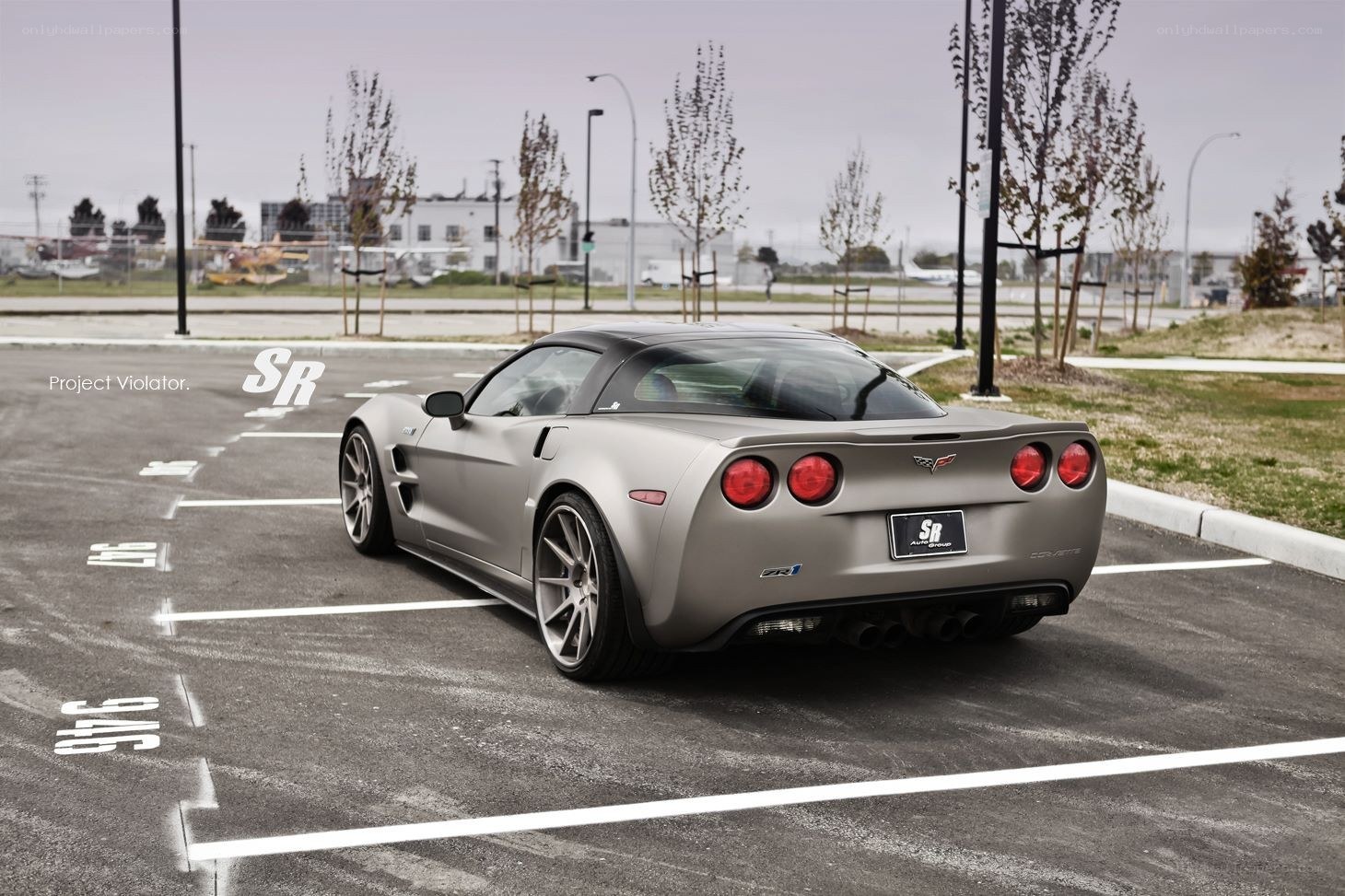 Silver Corvette in parking lot