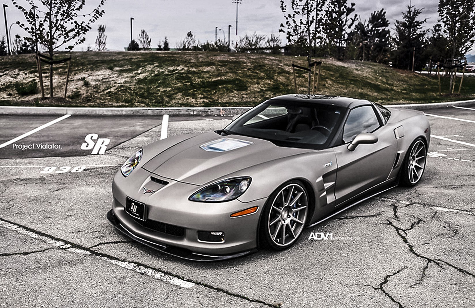 silver corvette in parking lot