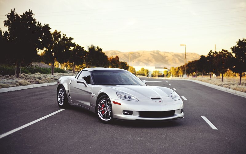silver corvette on a road