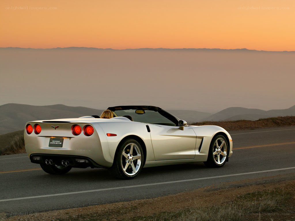 Silver Corvette on a scenic road