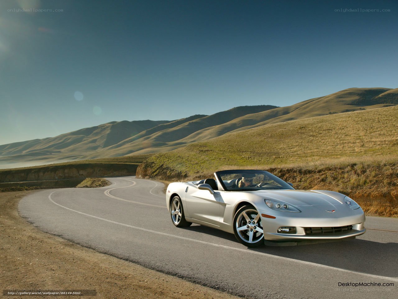 Silver Corvette on a winding road