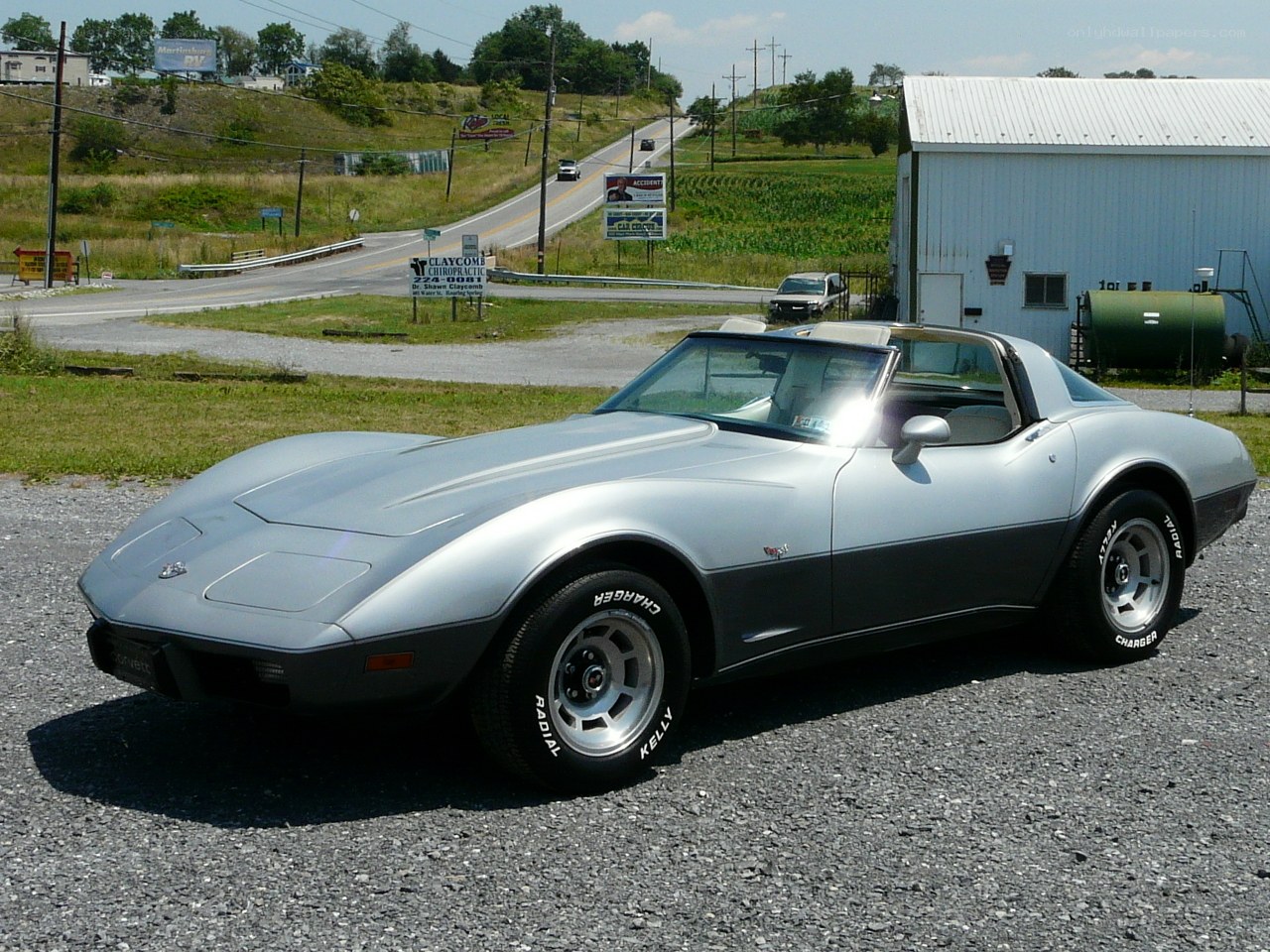 silver corvette on gravel