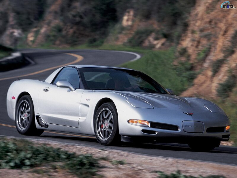 silver corvette on winding road