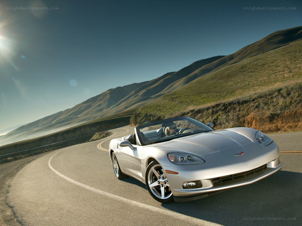 Silver Corvette on winding road