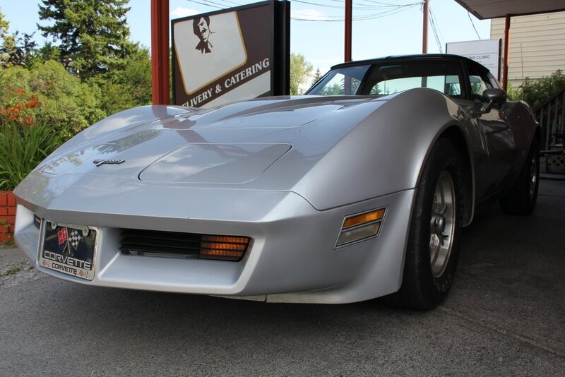 Silver Corvette parked outside