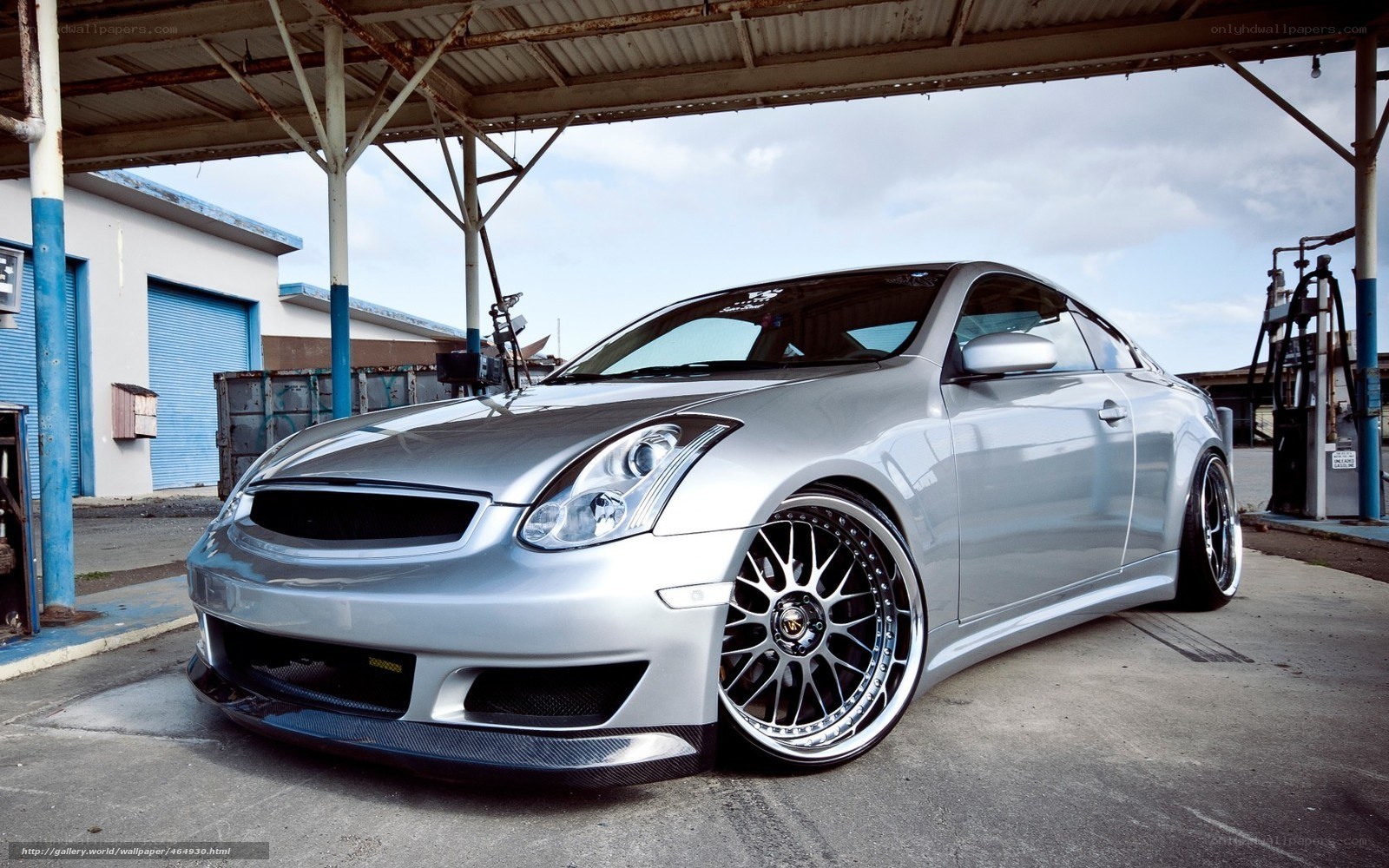 silver coupe at gas station