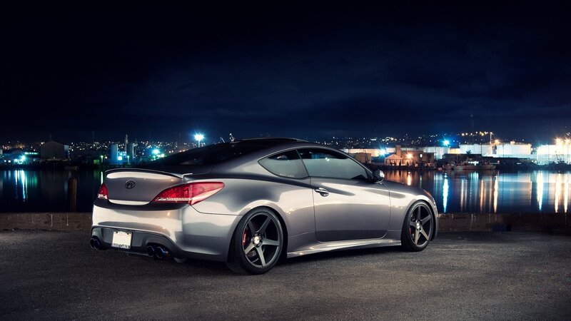 silver coupe at night by the water