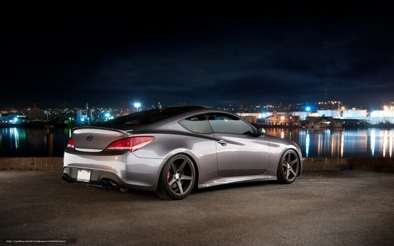 Silver coupe at night by the water