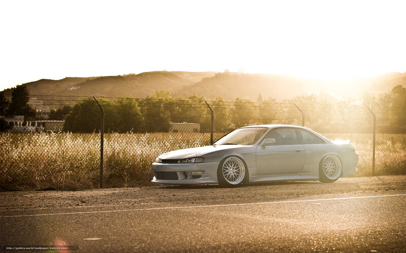silver coupe at sunset