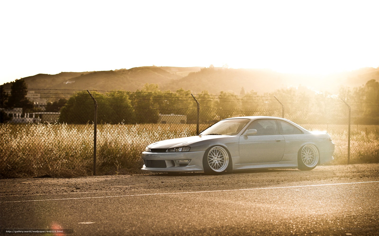 silver coupe at sunset