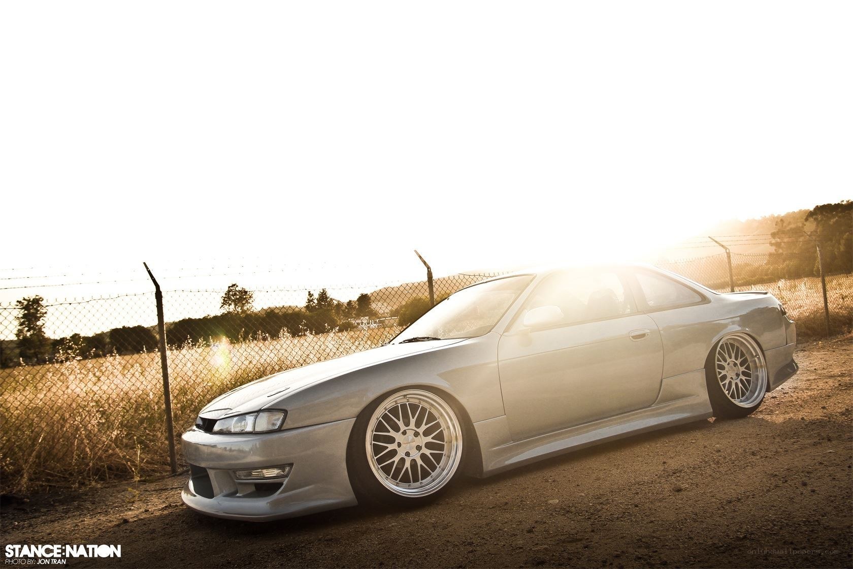silver coupe at sunset