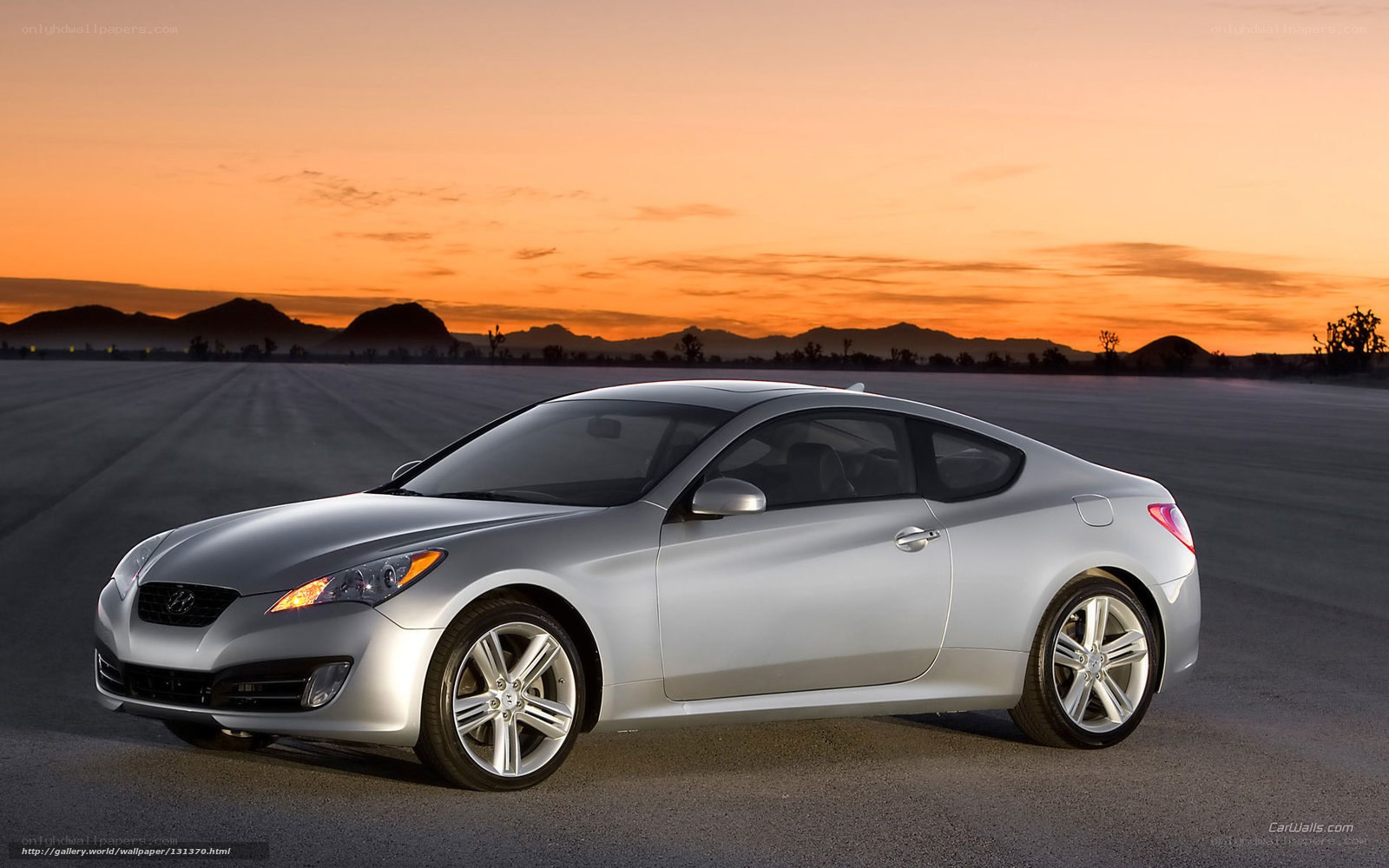 Silver coupe at sunset