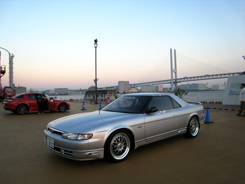 Silver coupe at waterfront
