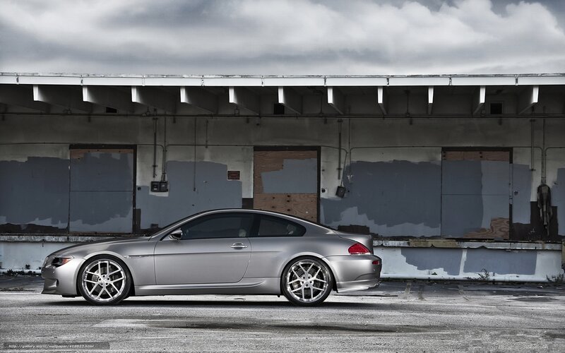 silver coupe in industrial lot