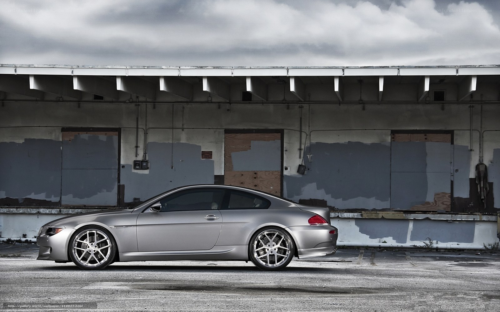 silver coupe in industrial lot