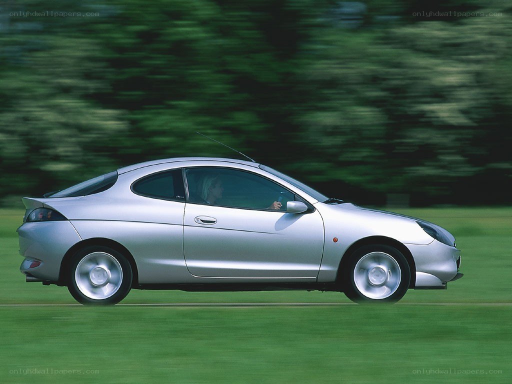 silver coupe in motion