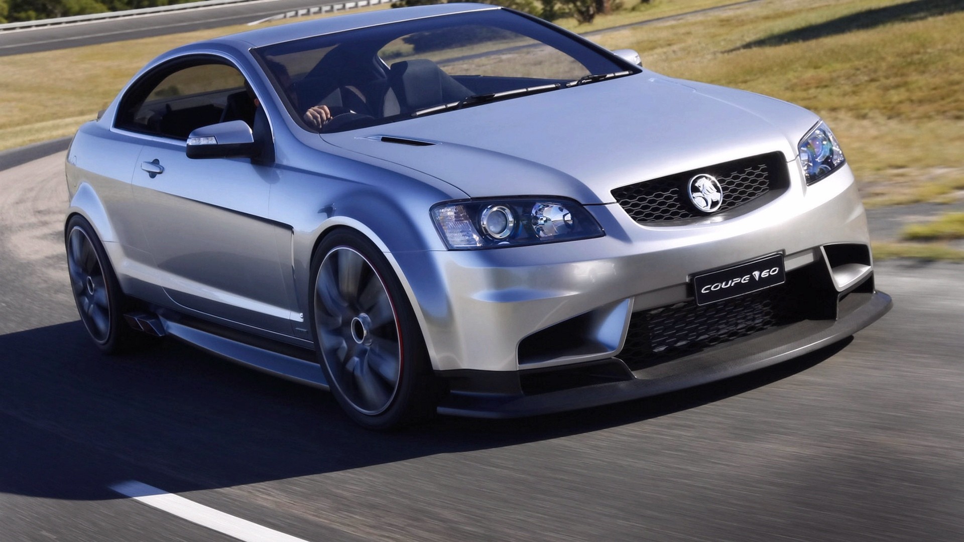 silver coupe in motion