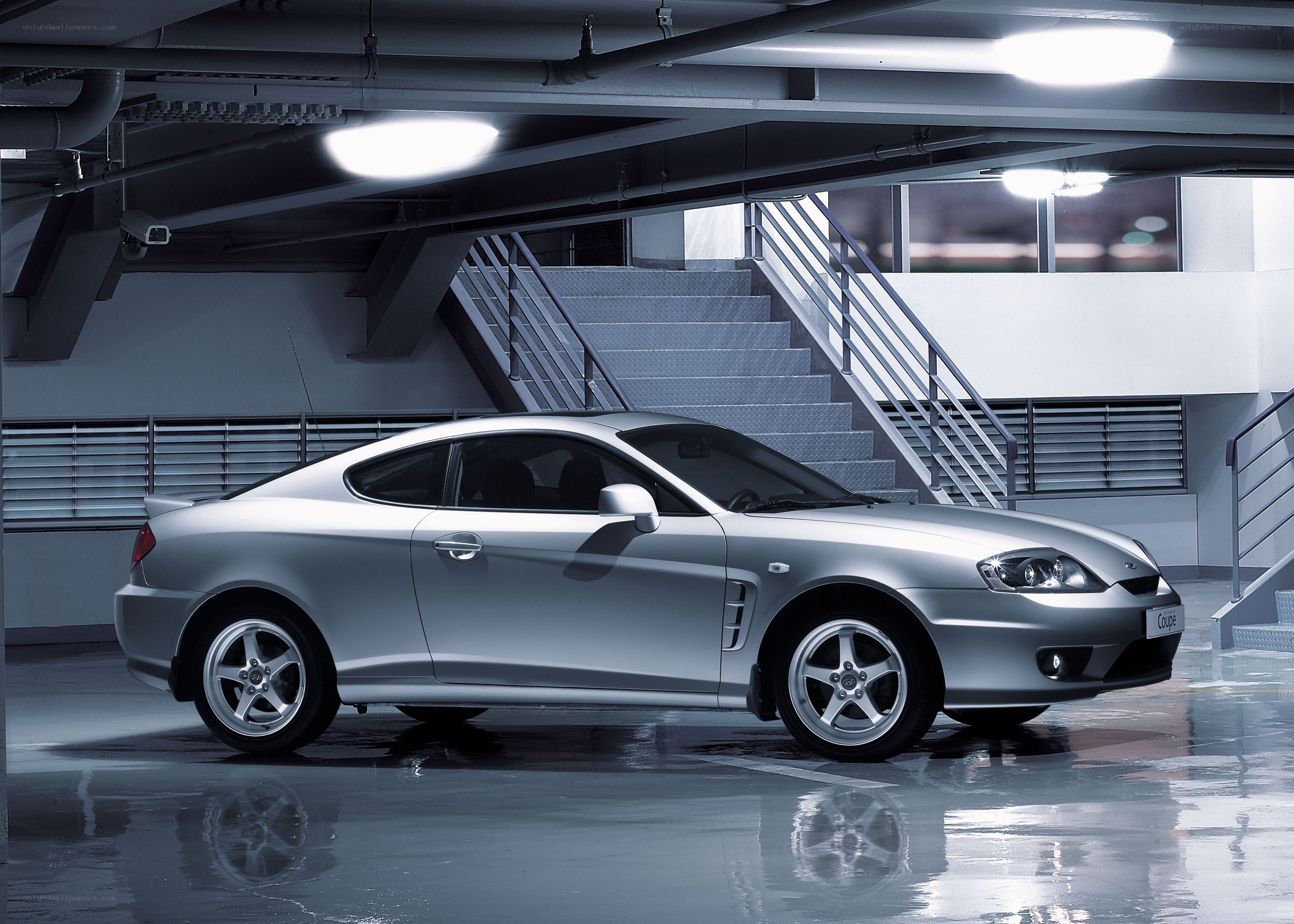 silver coupe in parking garage