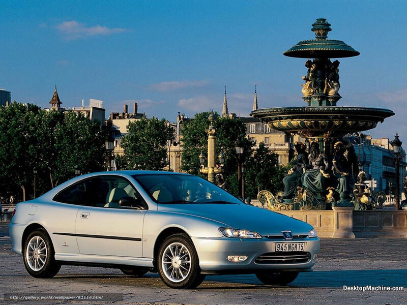 Silver coupe near ornate fountain