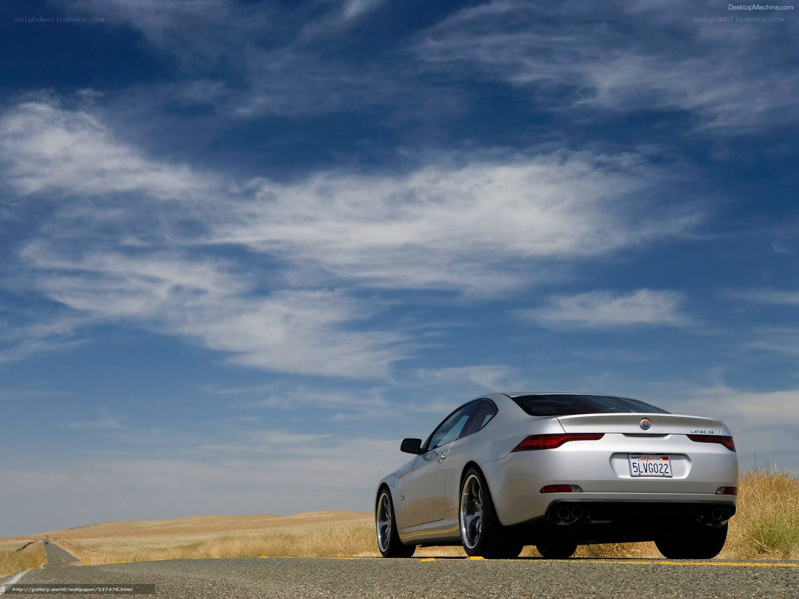 Silver coupe on a desert road