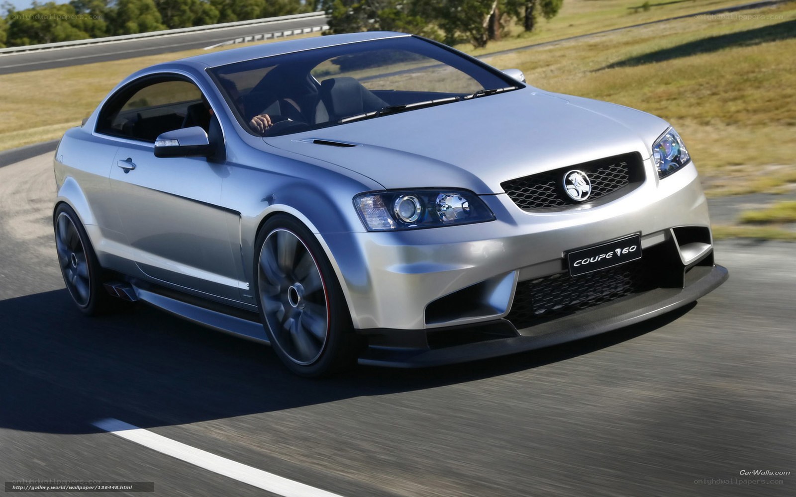 silver coupe on a racetrack