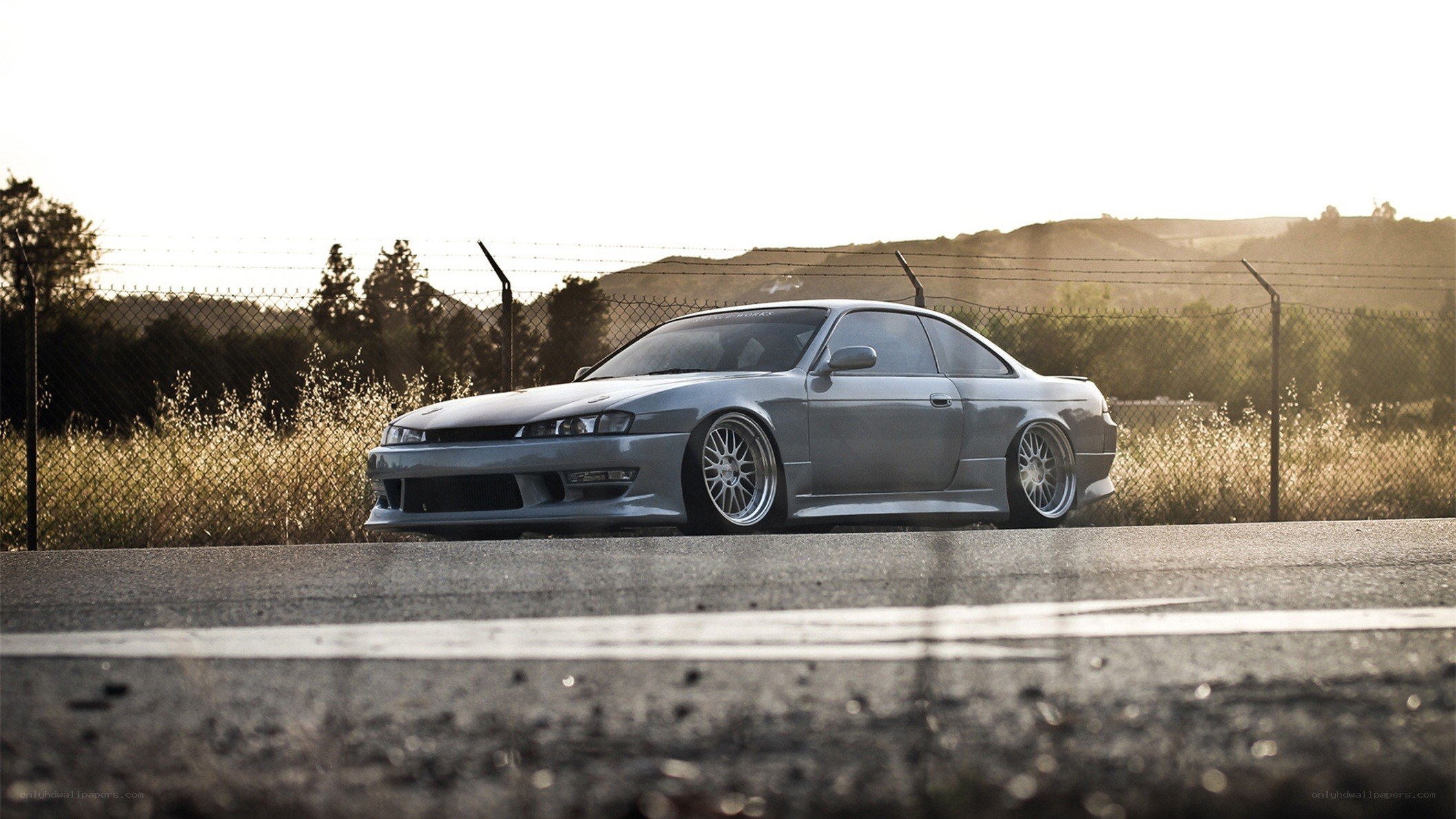 silver coupe on asphalt