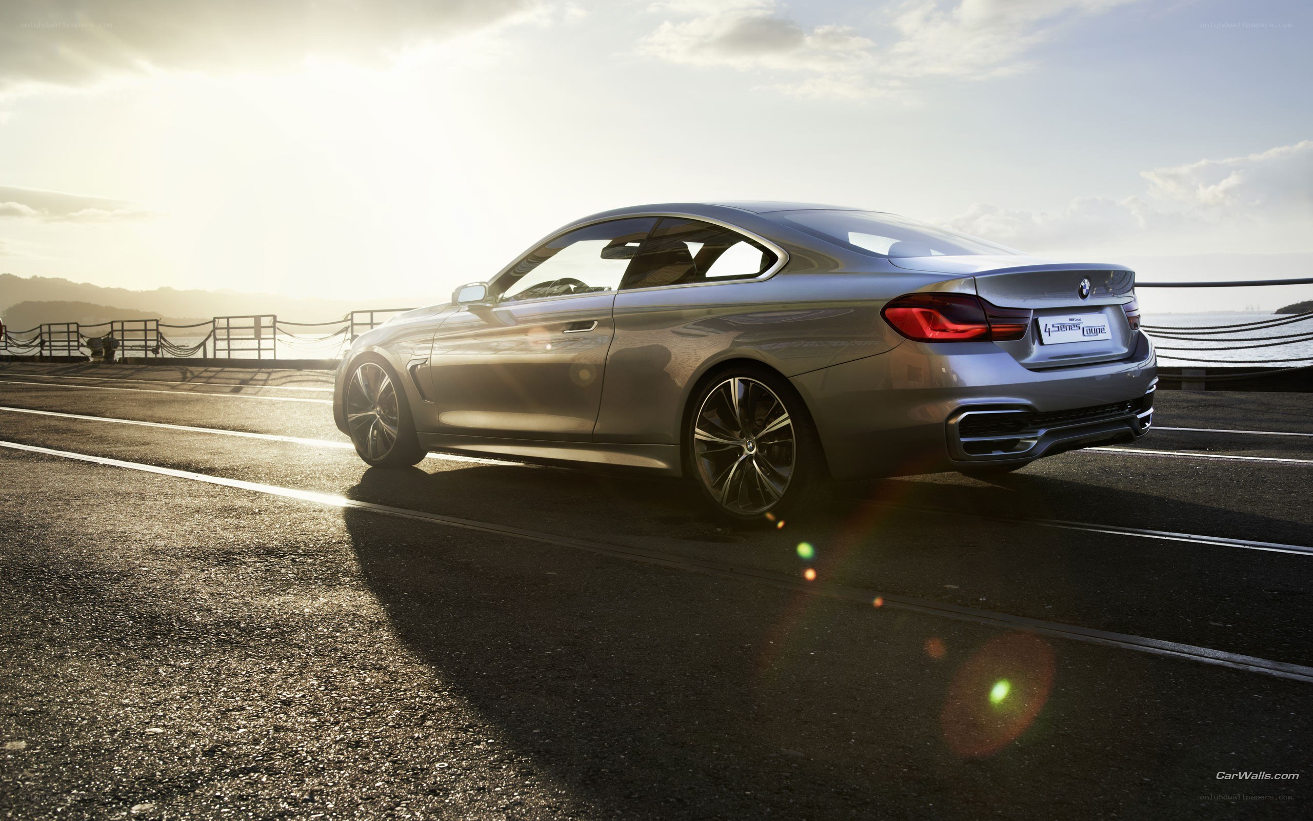 silver coupe on coastal road