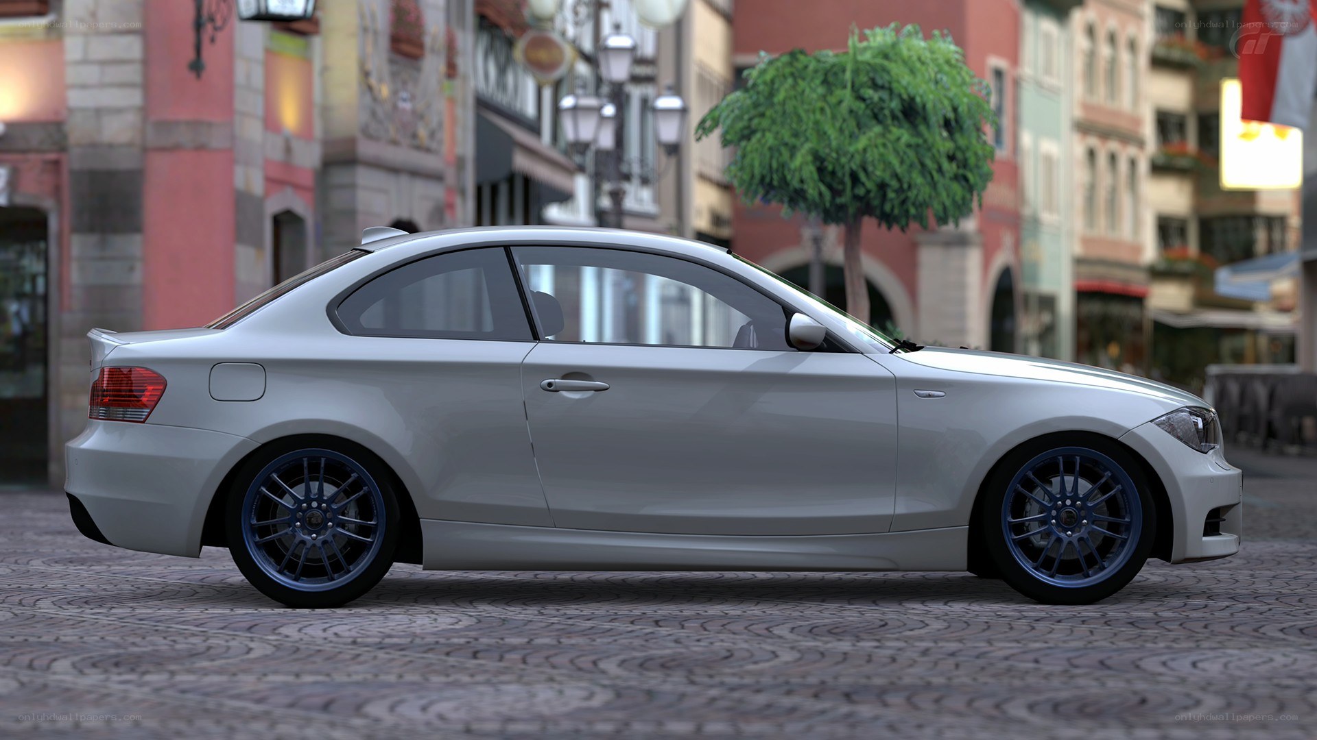 silver coupe on cobblestone street