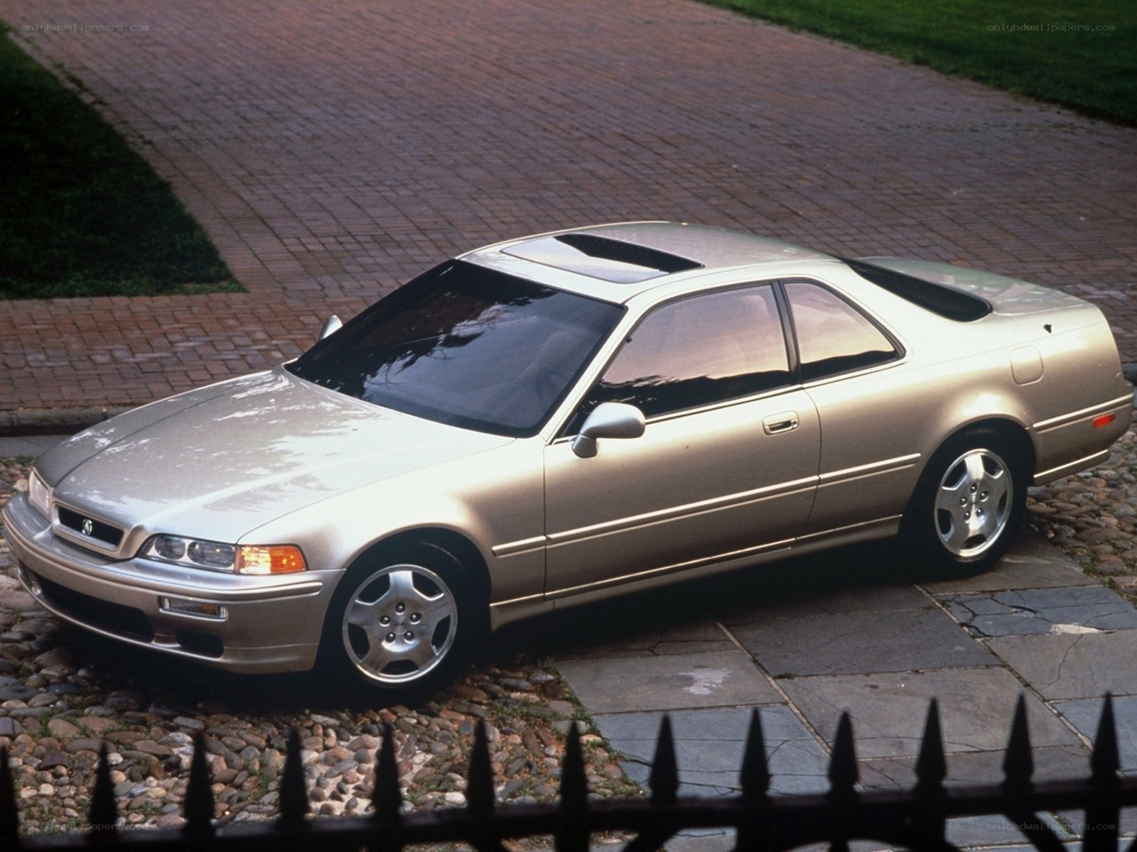 silver coupe on driveway