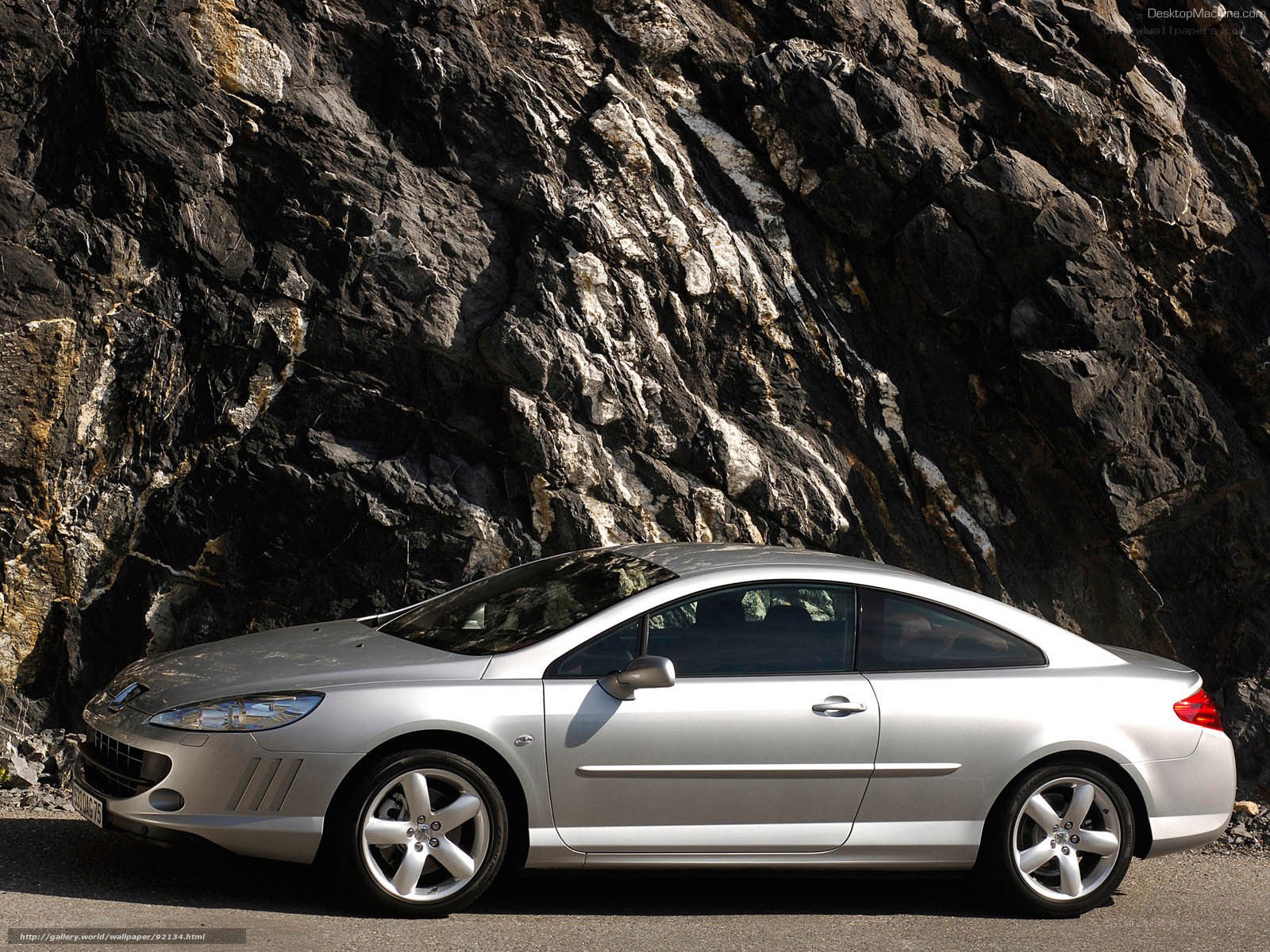 silver coupe on rocky road