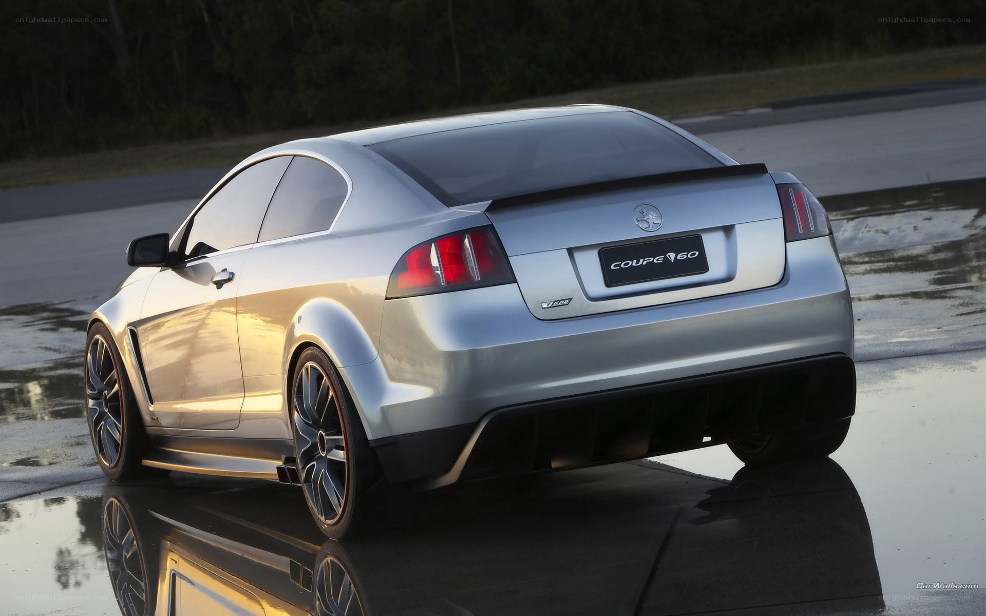 silver coupe on wet pavement