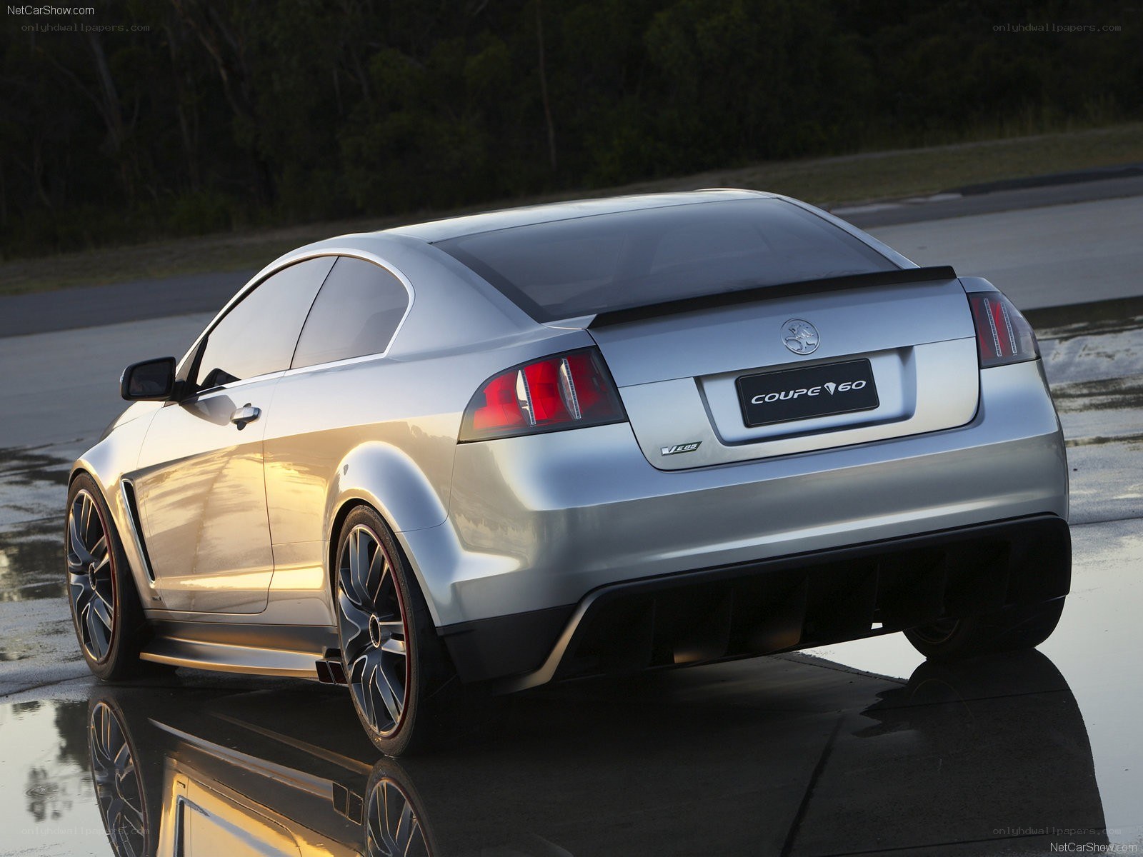 silver coupe on wet pavement