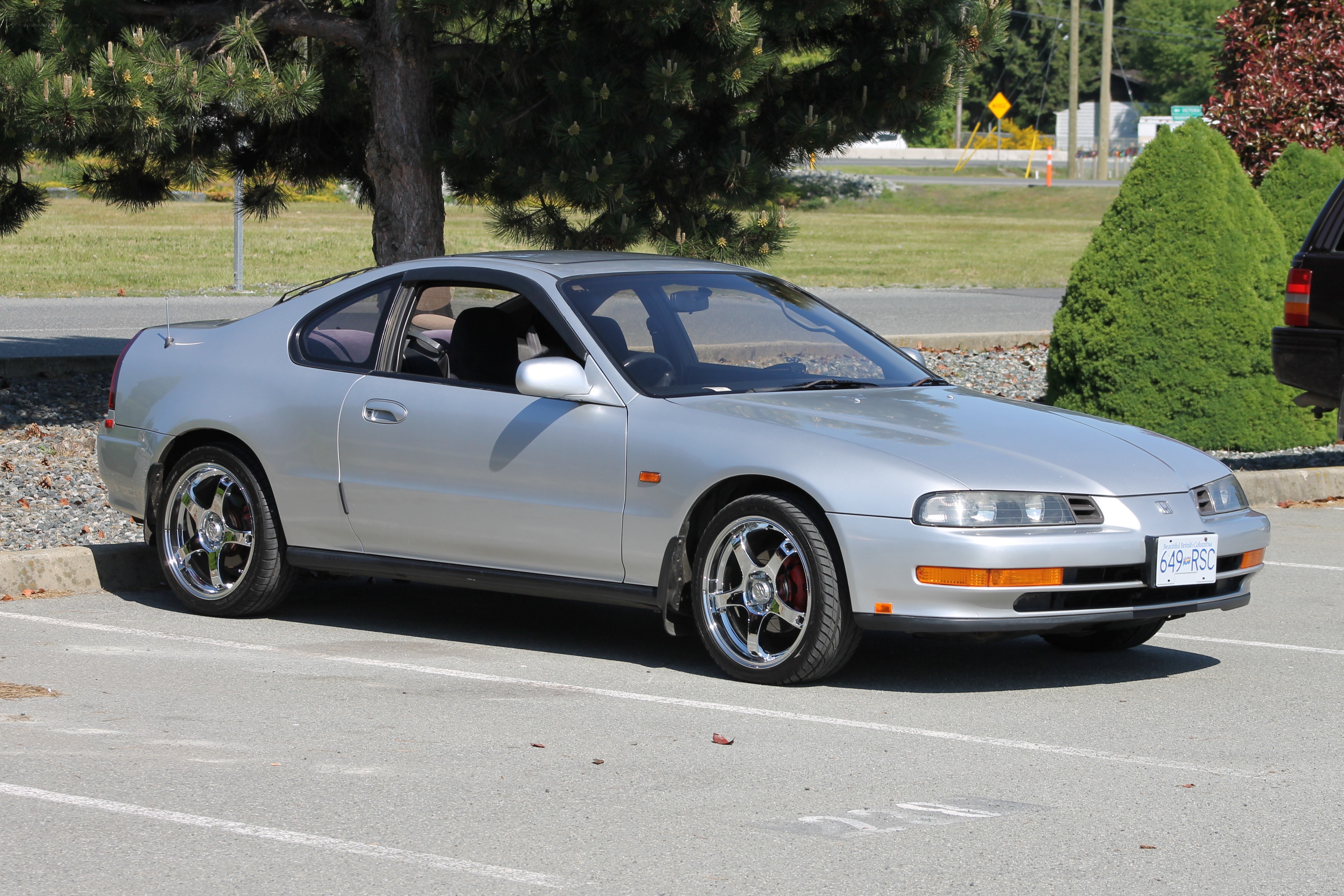 silver coupe parked in lot