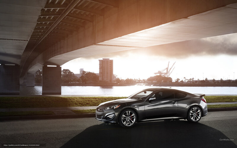 Silver coupe under a bridge