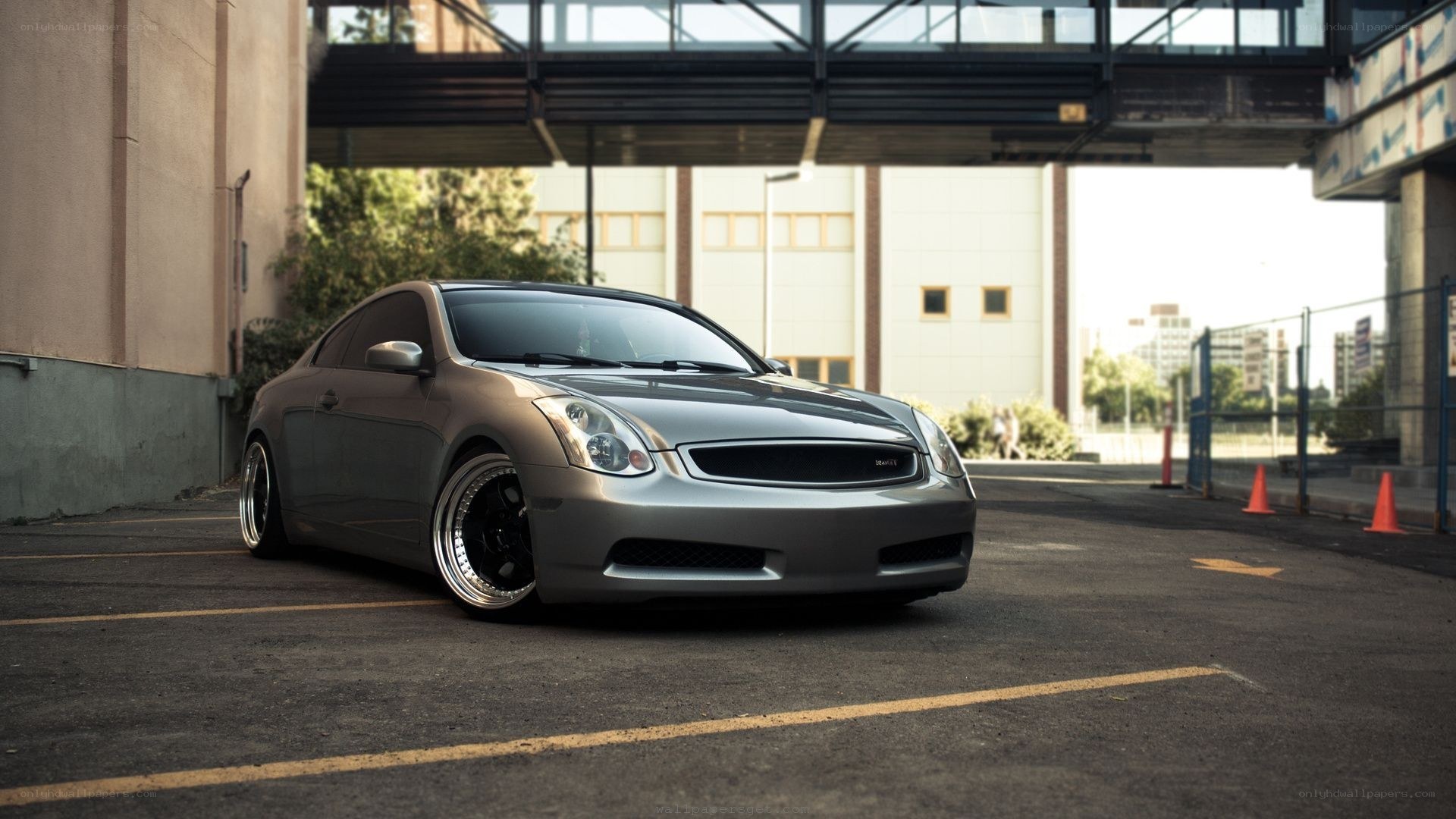 silver coupe under overpass