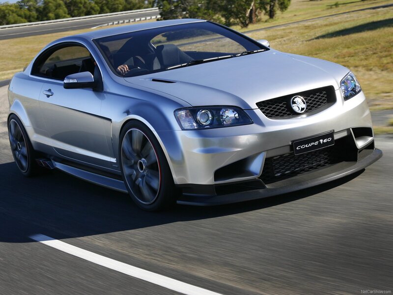 silver coupe v60 in motion