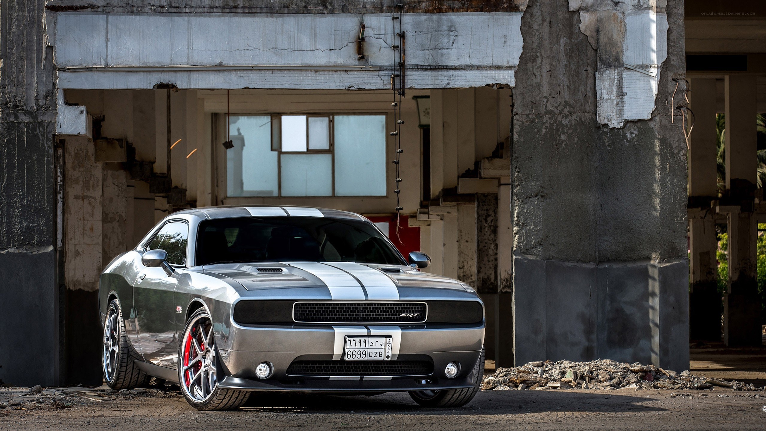 Silver Dodge Challenger in a ruin