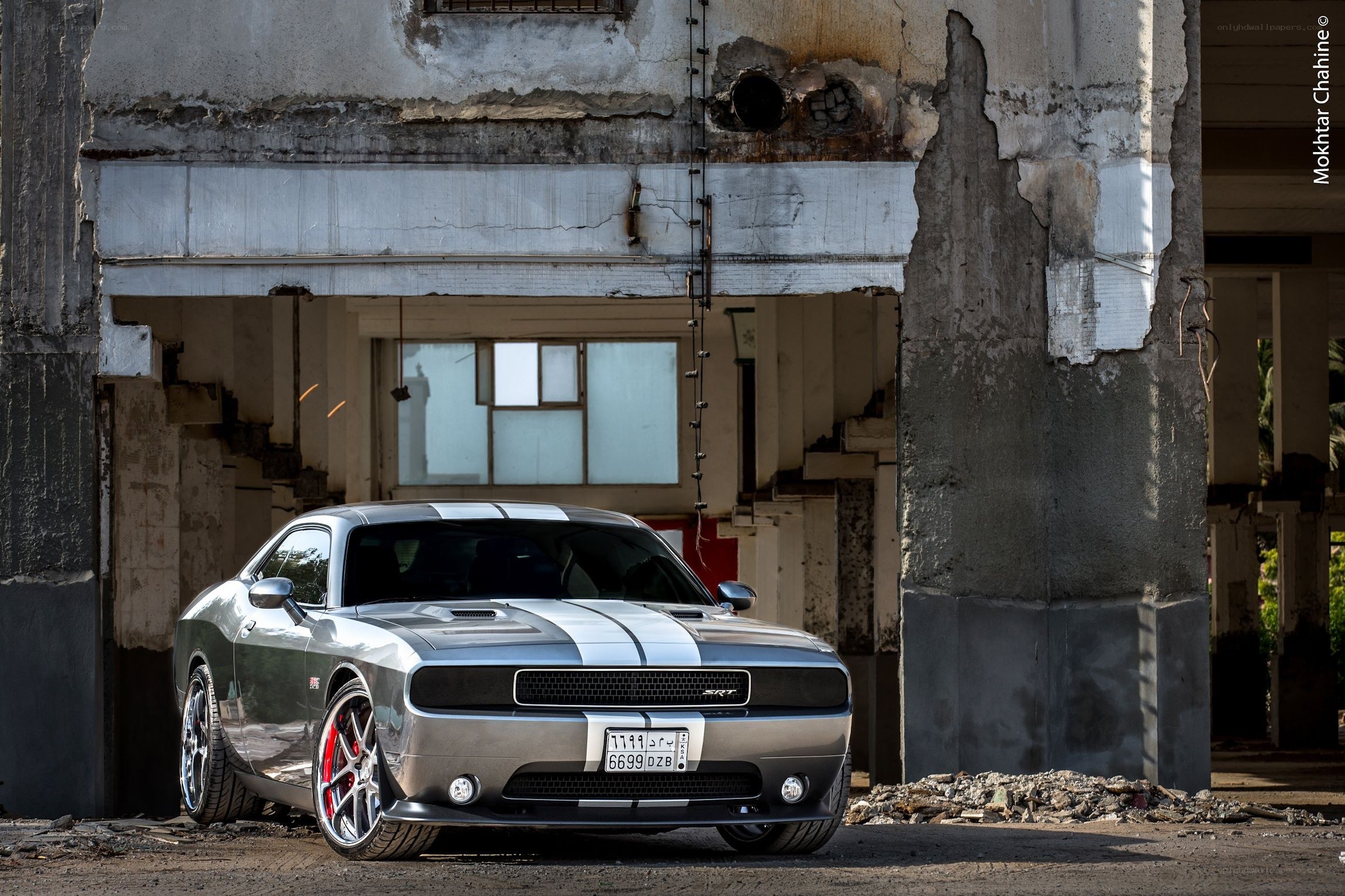 Silver Dodge Challenger in ruins